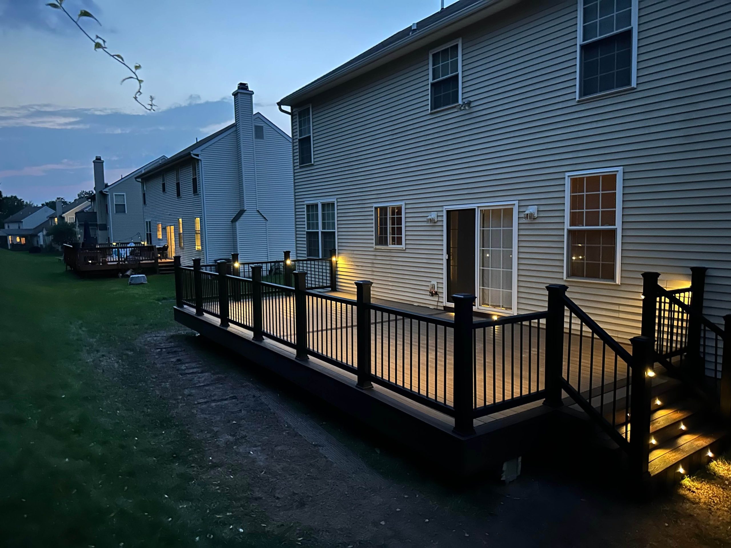 nighttime photo of a back deck that has been recently powerwashed