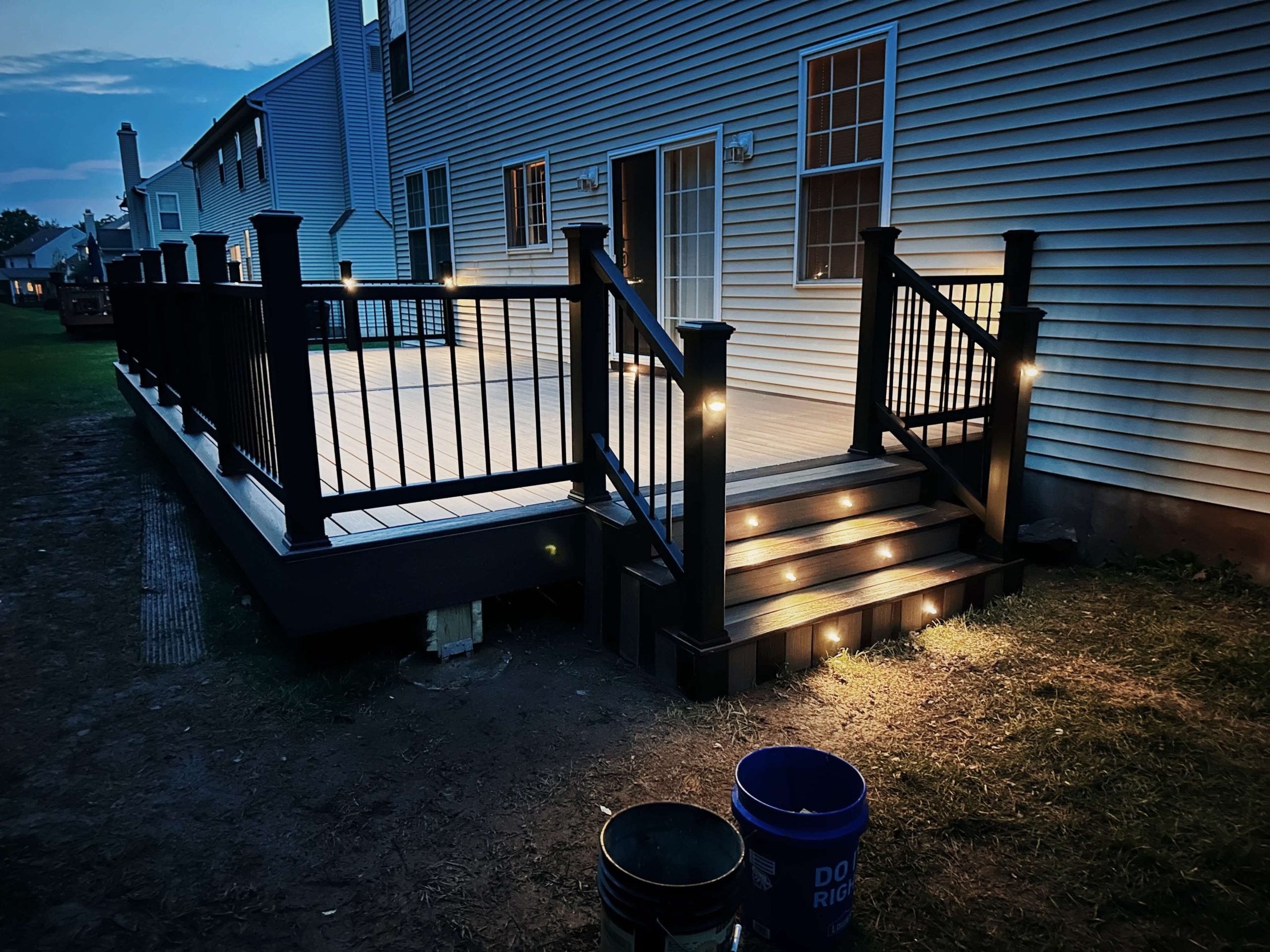 lit up steps of a backyard deck that has just been powerwashed